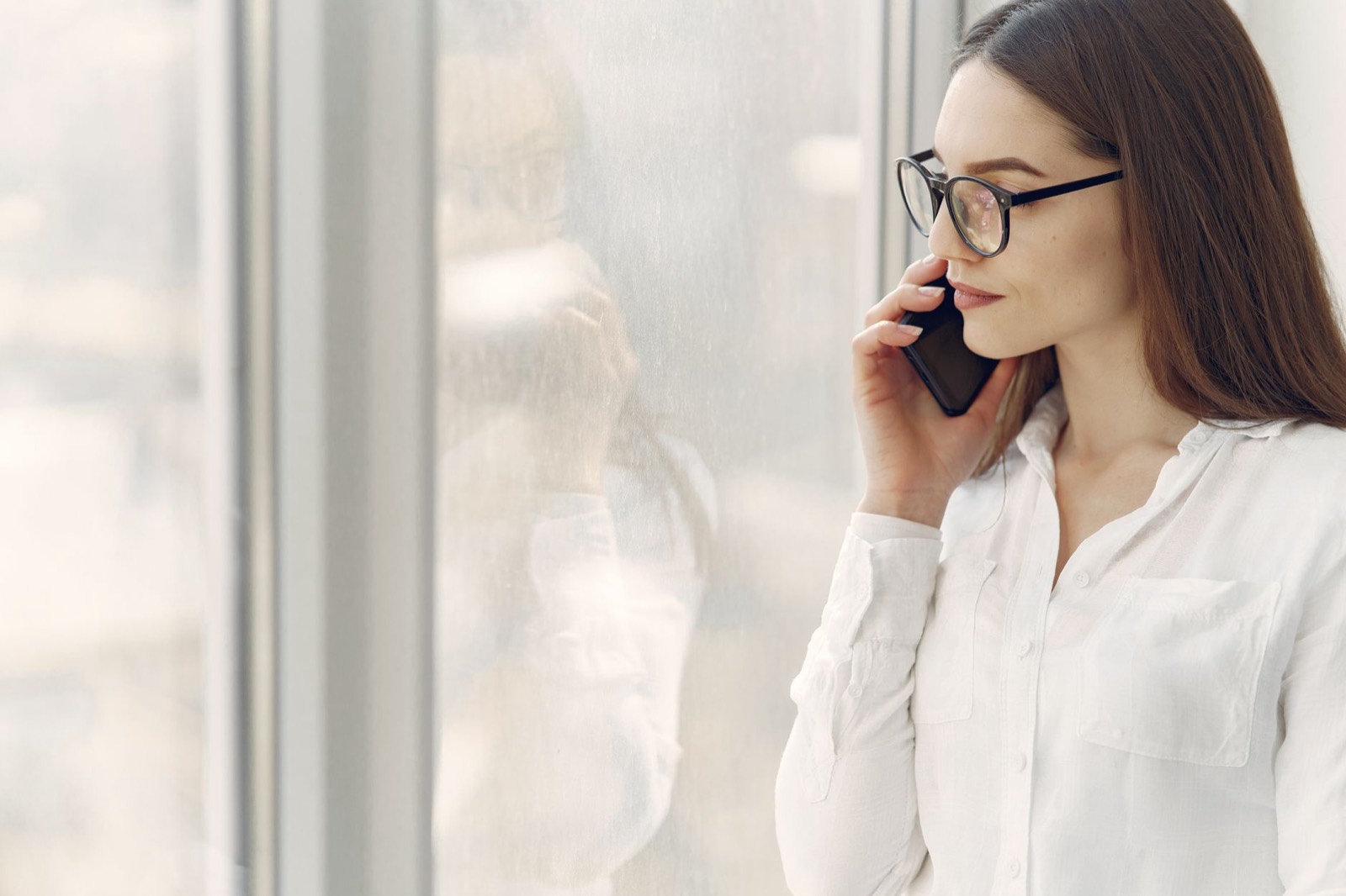 A person pausing to find the right word during a phone call